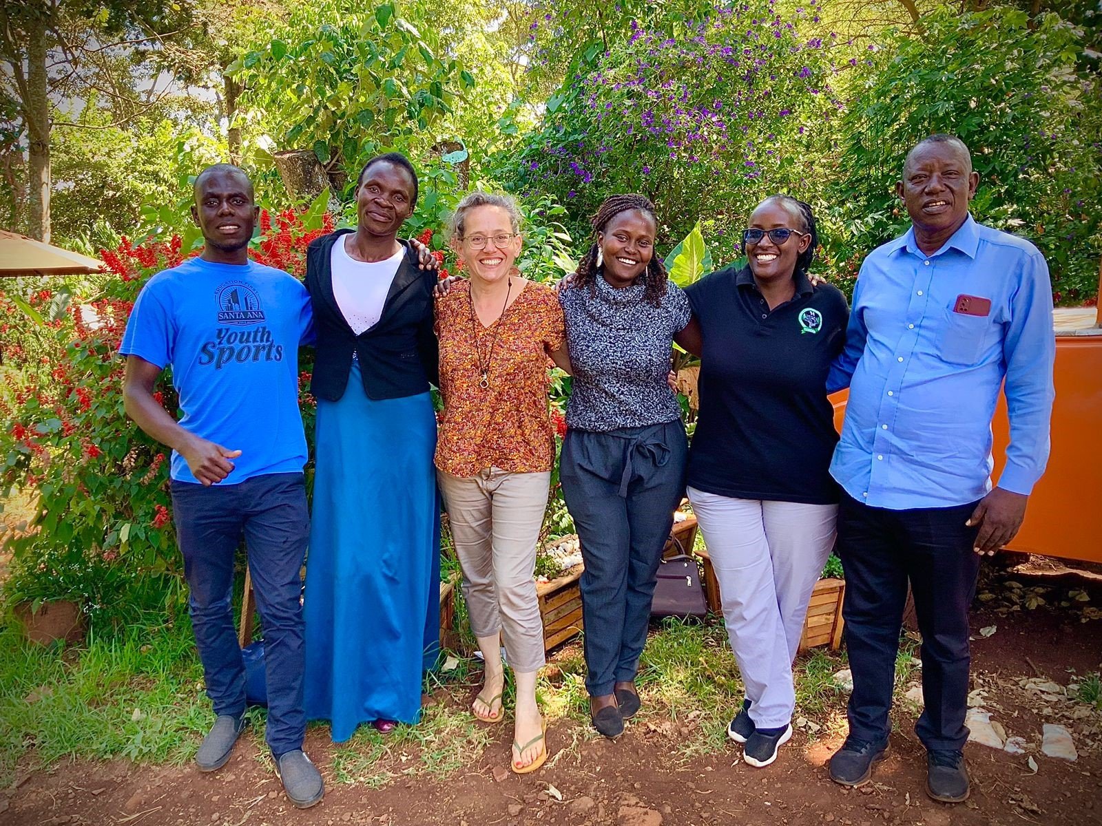The COSDEP team with partners in a garden